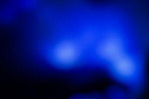 Abstract glowing blue light on dark background