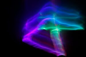 Neon blue and purple light form on black