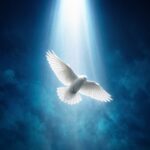 White dove descending through a shaft of light in a deep blue sky