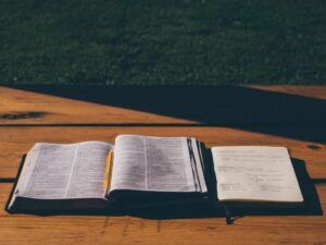 Open Bible on a wooden table in warm light