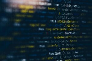 Blue-toned code on a screen with shallow focus
