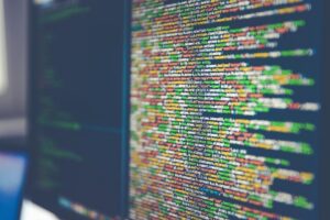 Colorful source code on a monitor, shallow focus