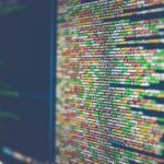 Colorful source code on a monitor, shallow focus